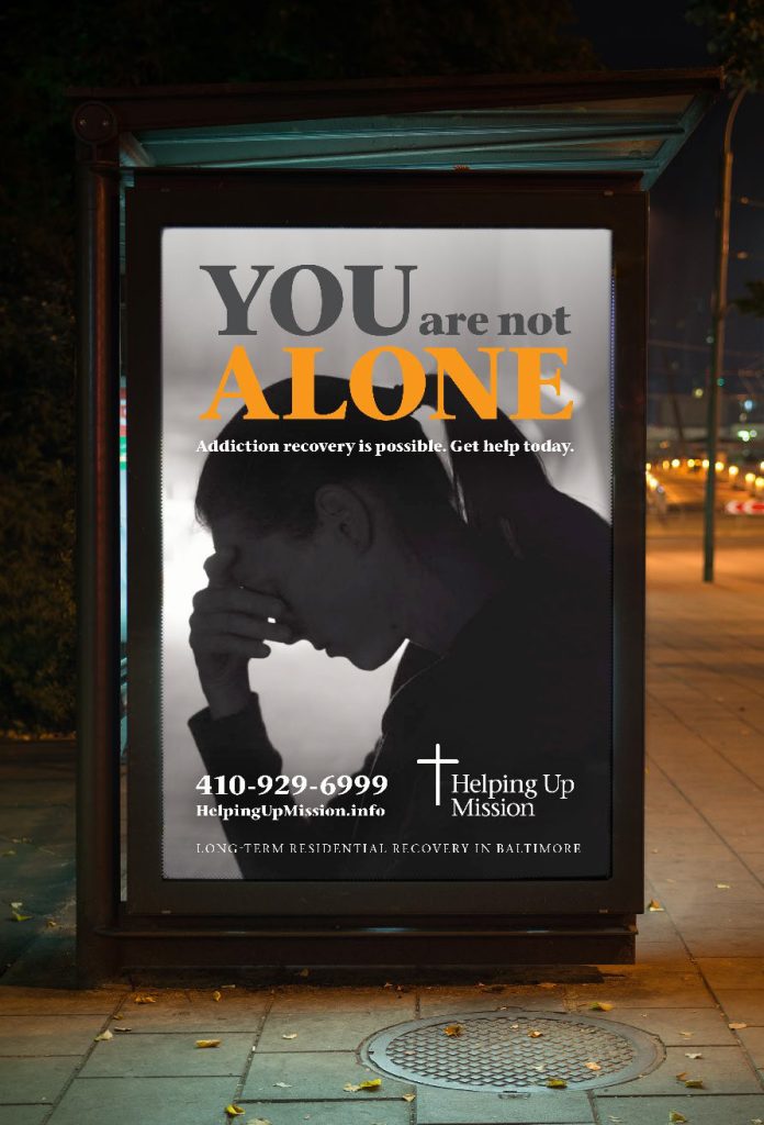 Helping Up Mission Awareness Campaign Poster at a Bus Stop